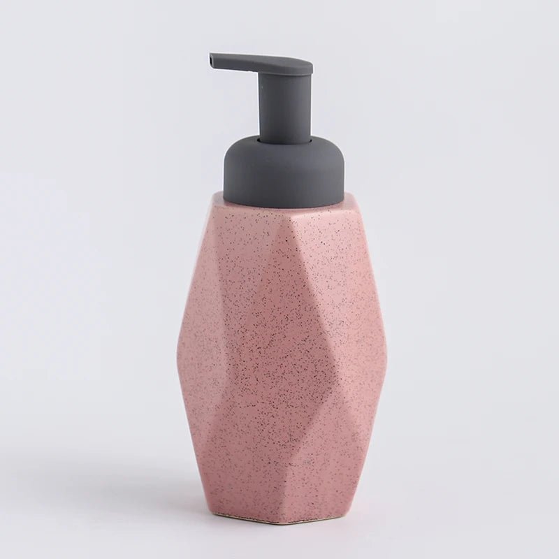 A pink ceramic soap dispenser with a sleek design, ideal for modern bathroom decor.