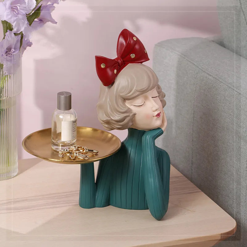 A charming girl statue holding a tray, perfect as a decorative piece.