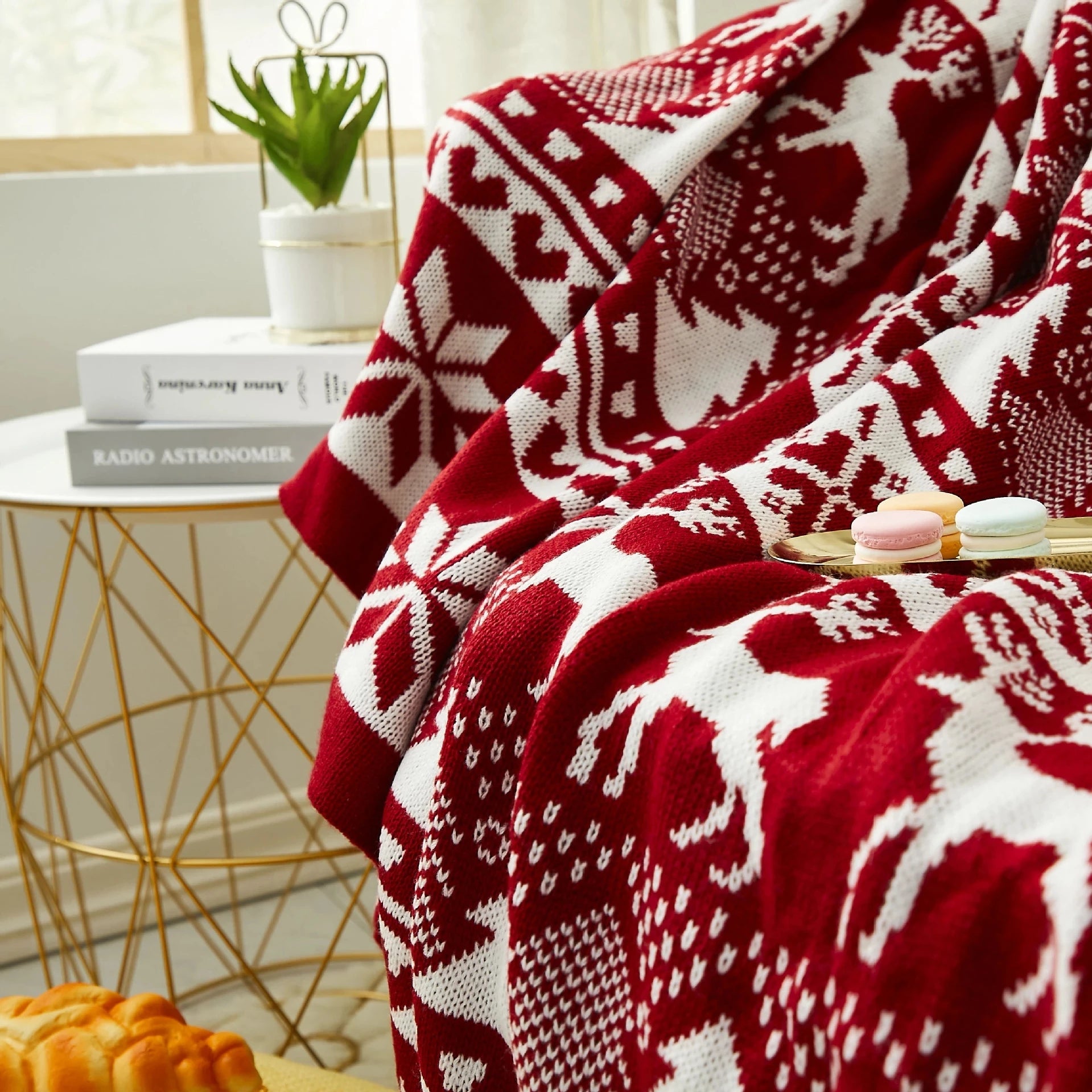 Soft red Christmas throw blanket with white reindeer and snowflake patterns, perfect for winter home decor. Ideal for keeping cosy and adding a festive touch to the living room or bedroom. Shop this warm, holiday-inspired throw at In Home Essentials for seasonal comfort and style.