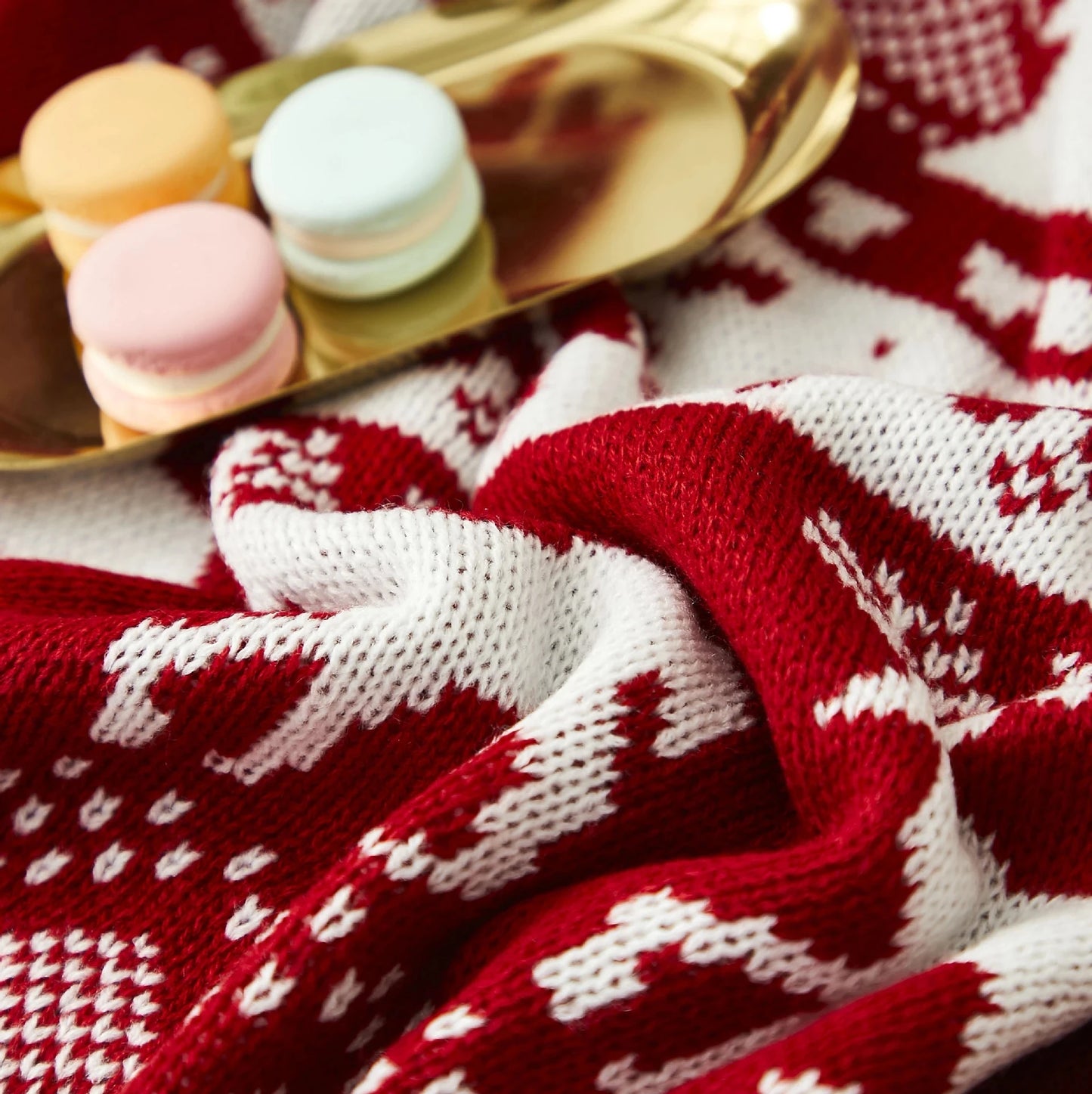 Soft red Christmas throw blanket with white reindeer and snowflake patterns, perfect for winter home decor. Ideal for keeping cosy and adding a festive touch to the living room or bedroom. Shop this warm, holiday-inspired throw at In Home Essentials for seasonal comfort and style.