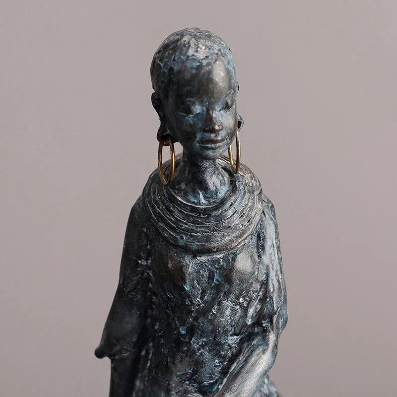 Resin African women sculptures with a retro, nostalgic style – perfect for contemporary or boho-chic spaces, featuring a wood-like base and oxidised metal finish.