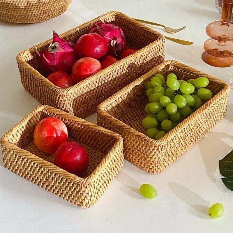 Three rectangular rustic fruit baskets filled with grapes and apples on a table