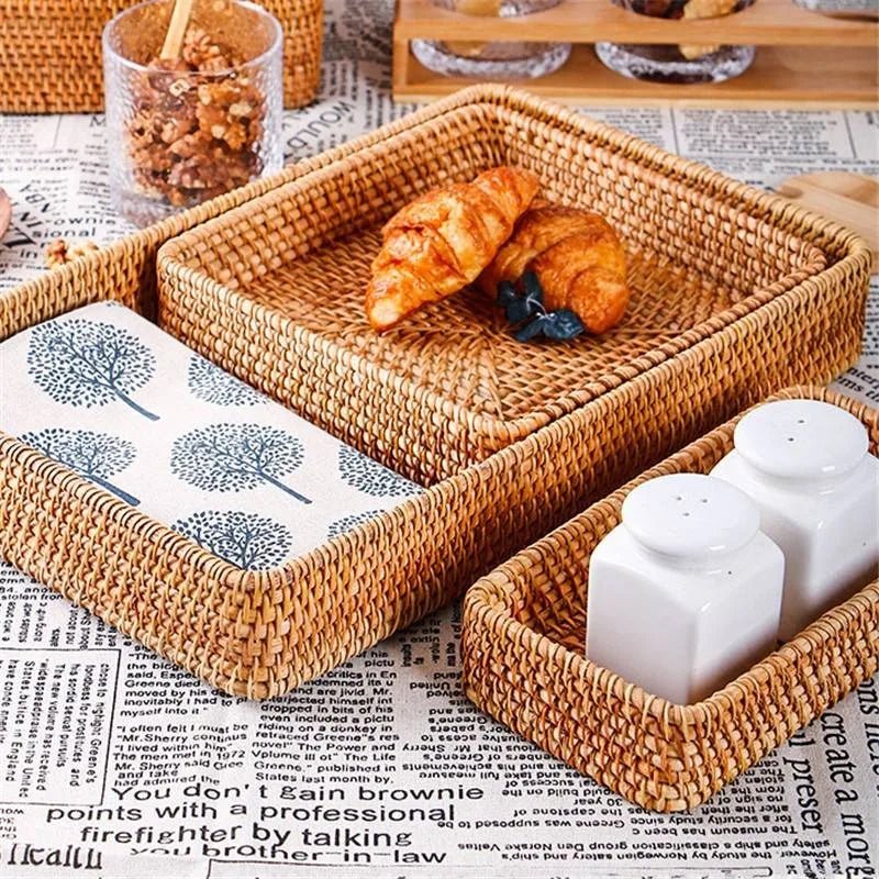 Three rustic fruit baskets filled with salt containers and two croissants