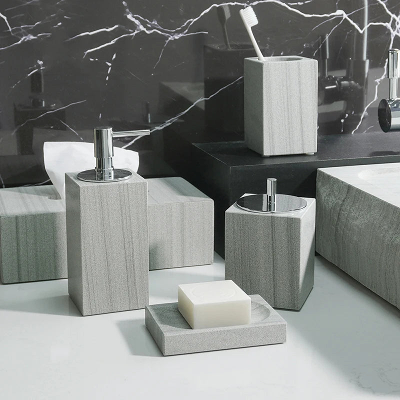 A sophisticated gray natural marble bathroom set, featuring a sleek soap dispenser, toothbrush holder, and soap dish, all crafted with premium marble for a modern and luxurious look.