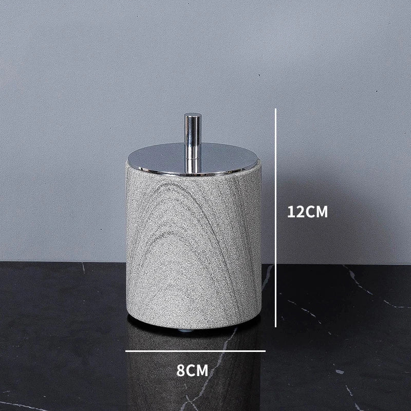 A sophisticated gray natural marble bathroom set, featuring a sleek soap dispenser, toothbrush holder, and soap dish, all crafted with premium marble for a modern and luxurious look.