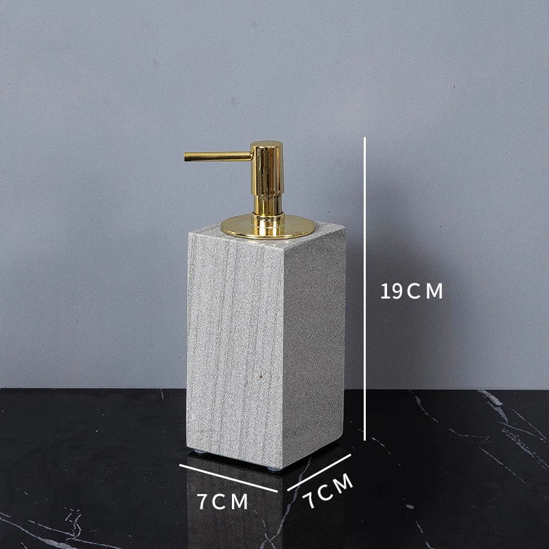 A sophisticated gray natural marble bathroom set, featuring a sleek soap dispenser, toothbrush holder, and soap dish, all crafted with premium marble for a modern and luxurious look.