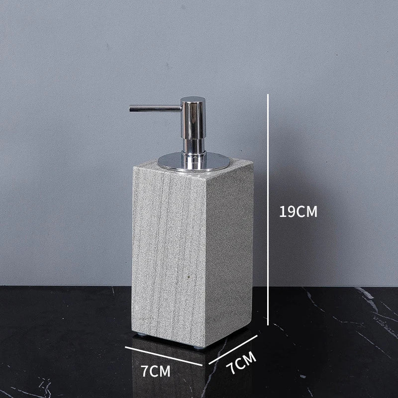 A sophisticated gray natural marble bathroom set, featuring a sleek soap dispenser, toothbrush holder, and soap dish, all crafted with premium marble for a modern and luxurious look.