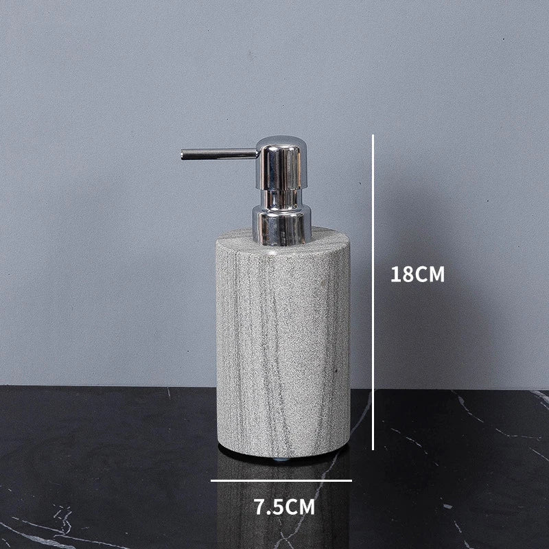 A sophisticated gray natural marble bathroom set, featuring a sleek soap dispenser, toothbrush holder, and soap dish, all crafted with premium marble for a modern and luxurious look.