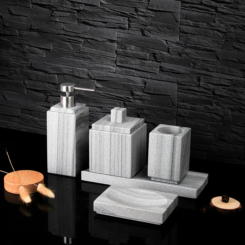 A sophisticated gray natural marble bathroom set, featuring a sleek soap dispenser, toothbrush holder, and soap dish, all crafted with premium marble for a modern and luxurious look.