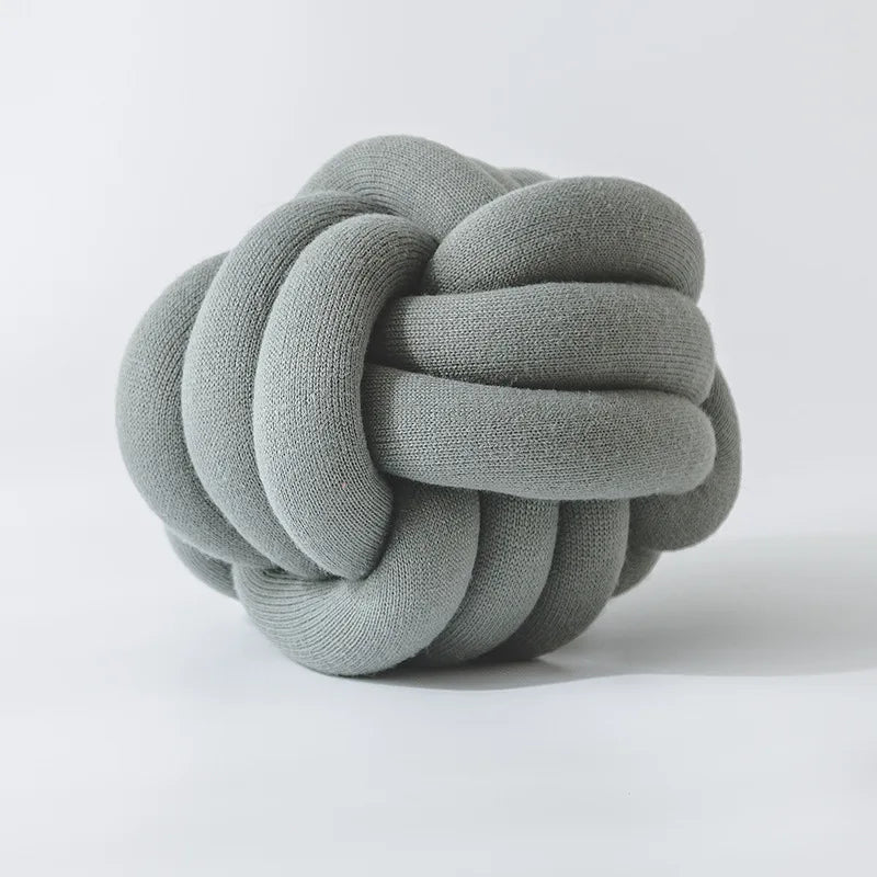 Stylish Knot Ball Sofa Cushion in a modern living room setting, featuring a soft, plush design