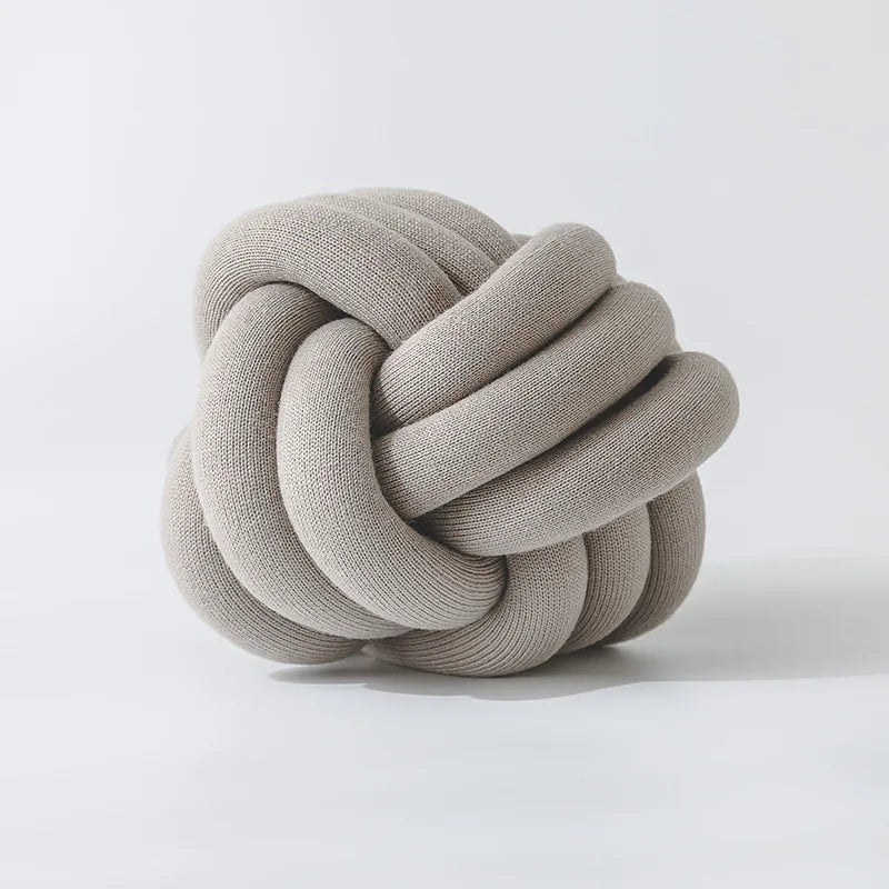 Stylish Knot Ball Sofa Cushion in a modern living room setting, featuring a soft, plush design