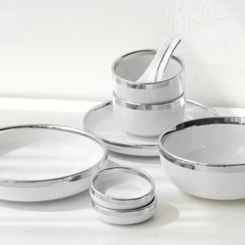 A stylish white and silver dinnerware set featuring a sleek design, perfect for elegant dining and special occasions.