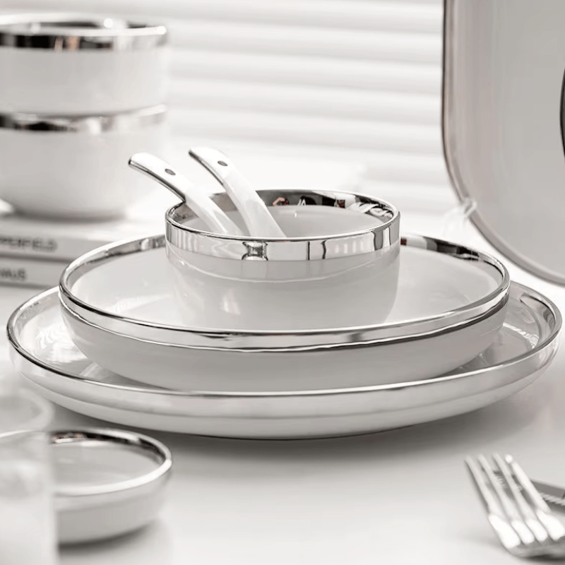 A stylish white and silver dinnerware set featuring a sleek design, perfect for elegant dining and special occasions.