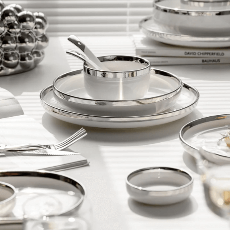 A stylish white and silver dinnerware set featuring a sleek design, perfect for elegant dining and special occasions.