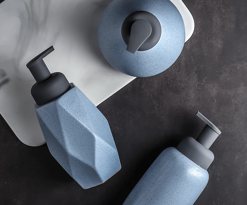 A blue ceramic soap dispenser with a sleek design, ideal for modern bathroom decor.