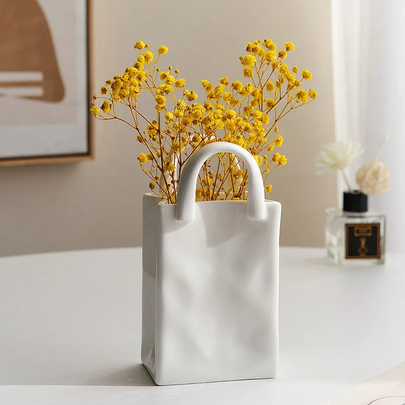 A tote-style ceramic vases filled with flowers, showcasing its elegant design and functionality for modern and classic home decor.