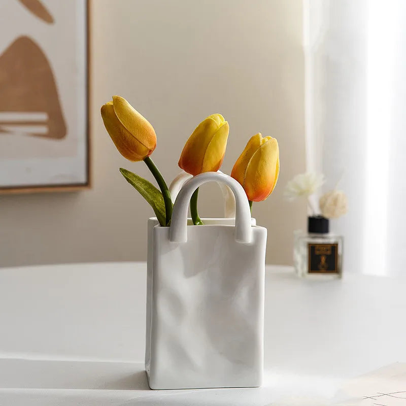 A tote-style ceramic vases filled with flowers, showcasing its elegant design and functionality for modern and classic home decor.