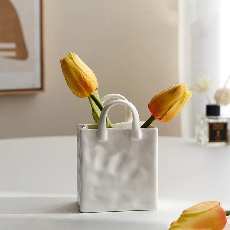 A tote-style ceramic vases filled with flowers, showcasing its elegant design and functionality for modern and classic home decor.