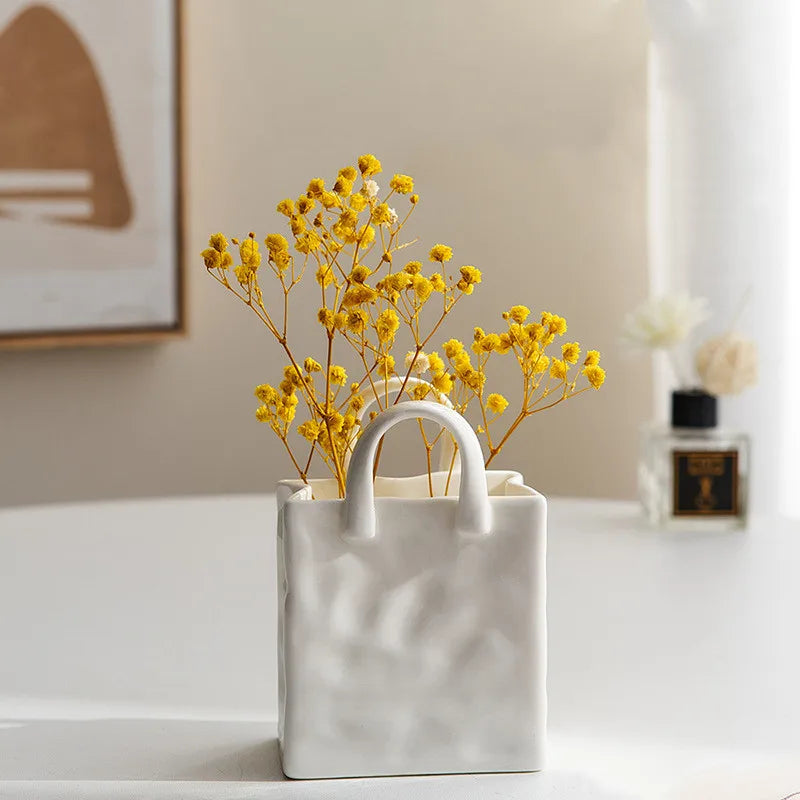 A tote-style ceramic vases filled with flowers, showcasing its elegant design and functionality for modern and classic home decor.