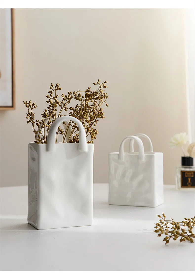 Two tote-style ceramic vases filled with flowers, showcasing their elegant design and functionality for modern and classic home decor.