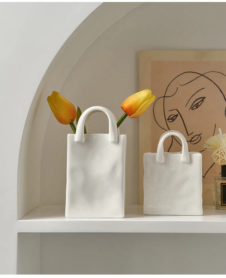 Two tote-style ceramic vases filled with flowers, showcasing their elegant design and functionality for modern and classic home decor.