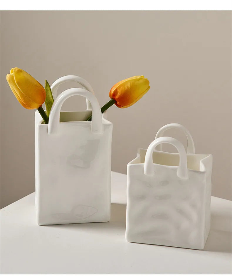 Two tote-style ceramic vases filled with flowers, showcasing their elegant design and functionality for modern and classic home decor.