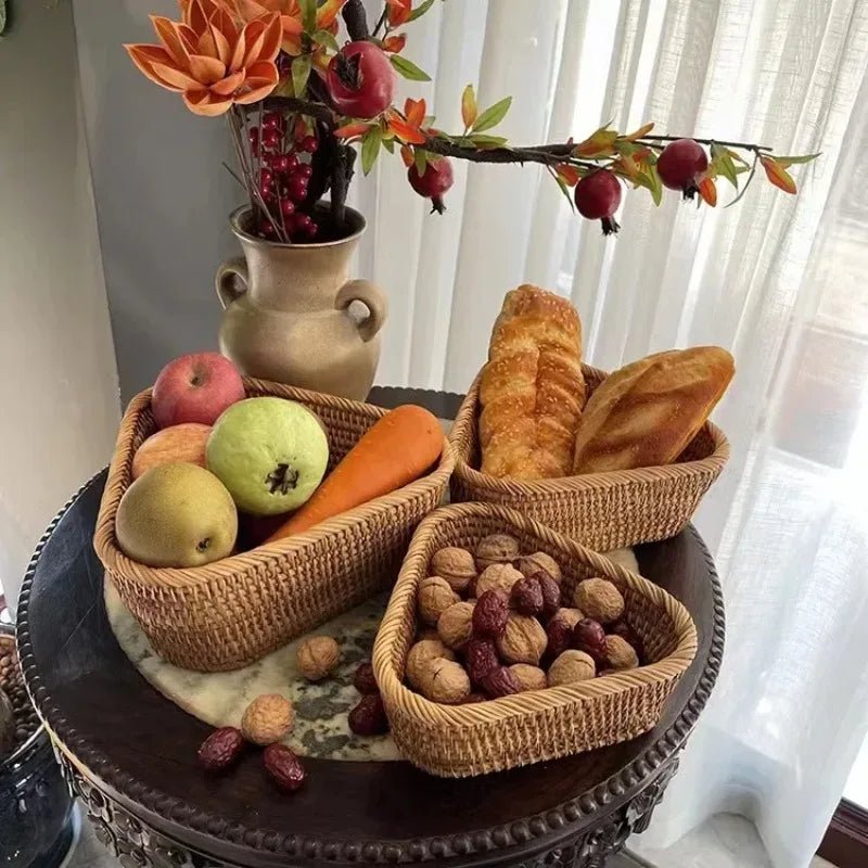 Three triangular rustic fruit baskets filled with assorted fruits, bread, and nuts