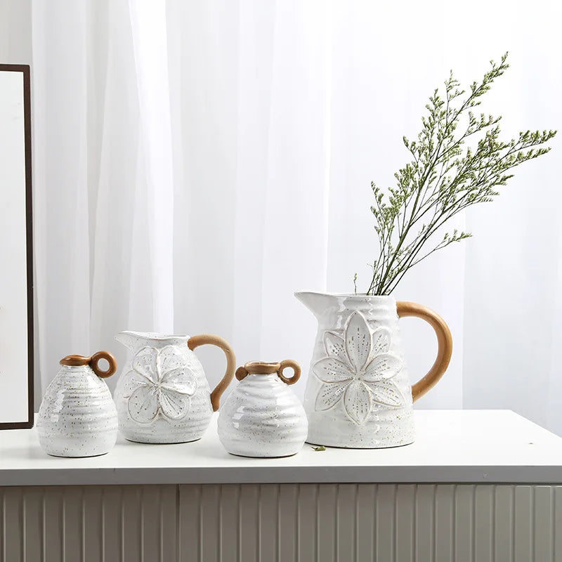 A set of four Vintage Charm Ceramic Vases with handles, displaying intricate vintage designs perfect for adding an elegant touch to home decor.