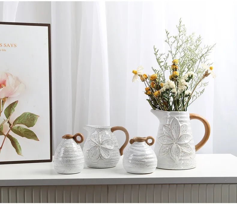 A set of four Vintage Charm Ceramic Vases with handles, displaying intricate vintage designs perfect for adding an elegant touch to home decor.