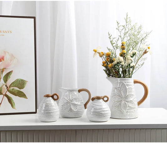 A set of four Vintage Charm Ceramic Vases with handles, displaying intricate vintage designs perfect for adding an elegant touch to home decor.