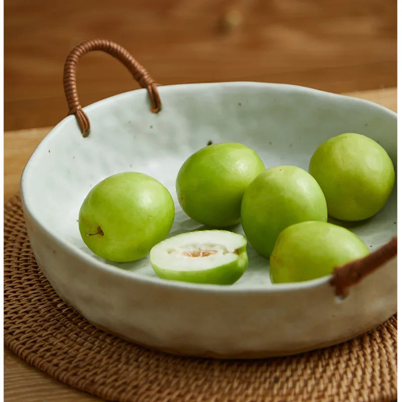 Vintage clay serving bowl with woven handles, perfect for meals or as a decorative centrepiece.