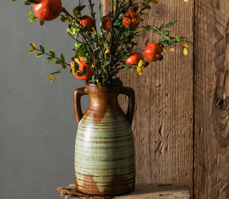 A beautifully crafted vintage two-handled ceramic vase with intricate detailing.