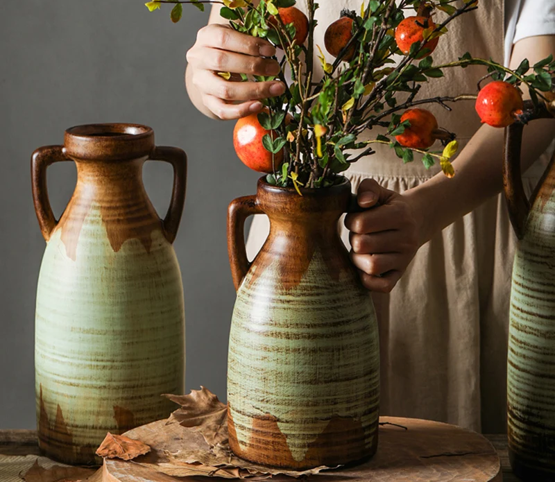 A beautifully crafted vintage two-handled ceramic vase with intricate detailing.