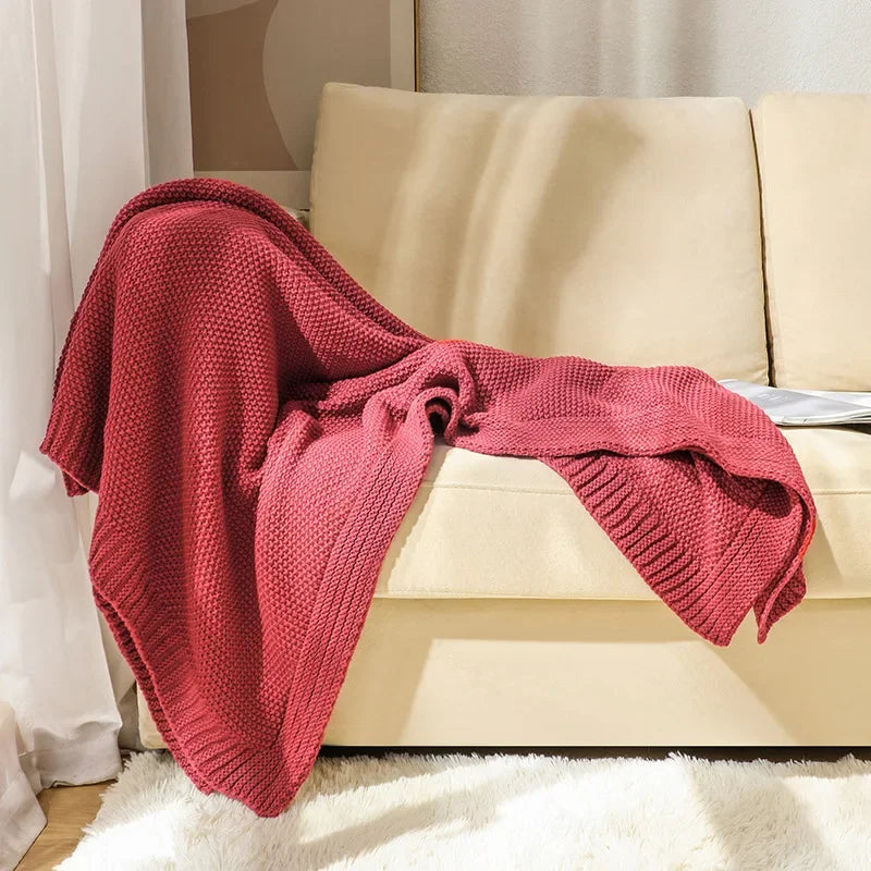 Waffle knitted wool blanket in solid colours, ideal for beds, sofas, and office naps. Soft, warm, and cosy for all-day comfort in contemporary spaces.