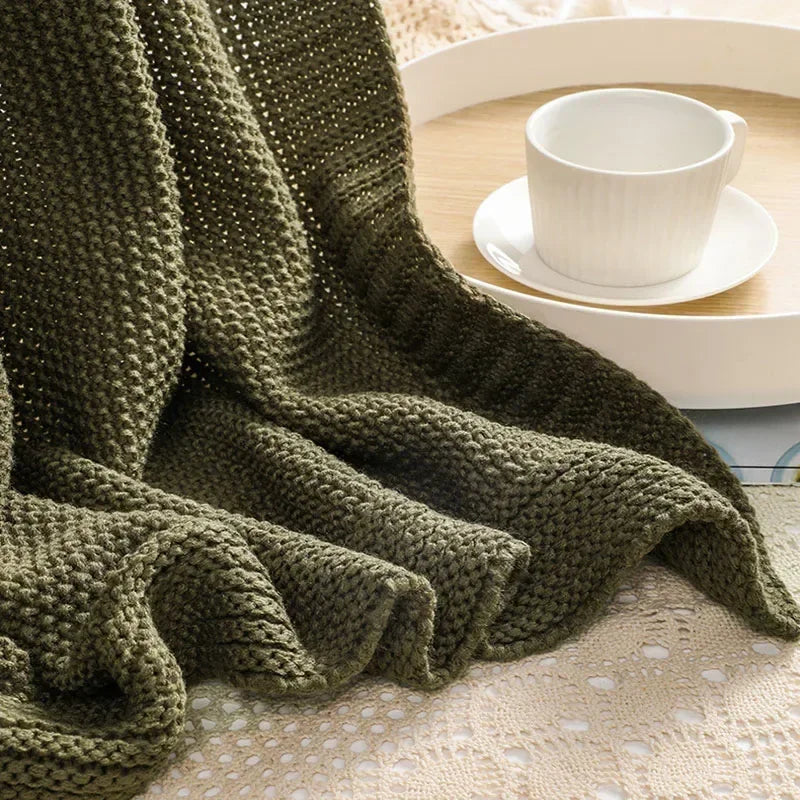 Waffle knitted wool blanket in solid colours, ideal for beds, sofas, and office naps. Soft, warm, and cosy for all-day comfort in contemporary spaces.