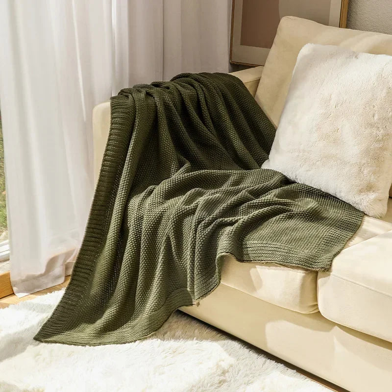 Waffle knitted wool blanket in solid colours, ideal for beds, sofas, and office naps. Soft, warm, and cosy for all-day comfort in contemporary spaces.