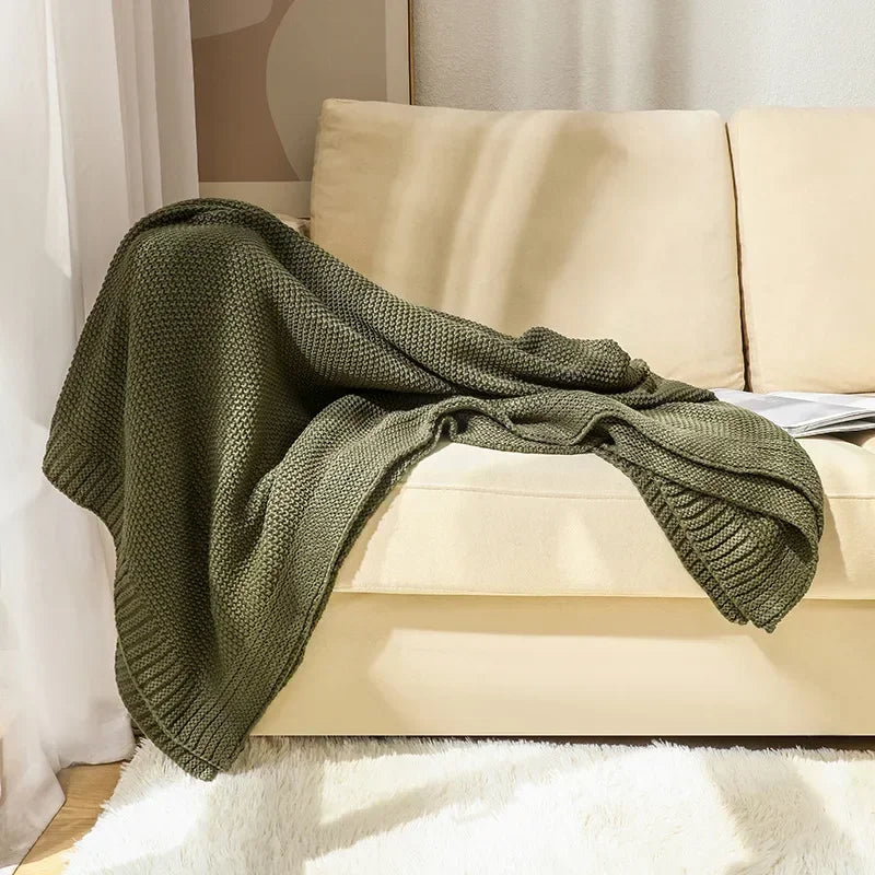 Waffle knitted wool blanket in solid colours, ideal for beds, sofas, and office naps. Soft, warm, and cosy for all-day comfort in contemporary spaces.