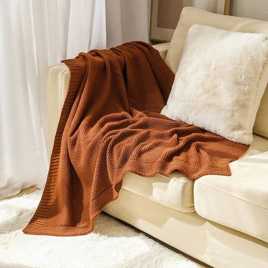 Waffle knitted wool blanket in solid colours, ideal for beds, sofas, and office naps. Soft, warm, and cosy for all-day comfort in contemporary spaces.