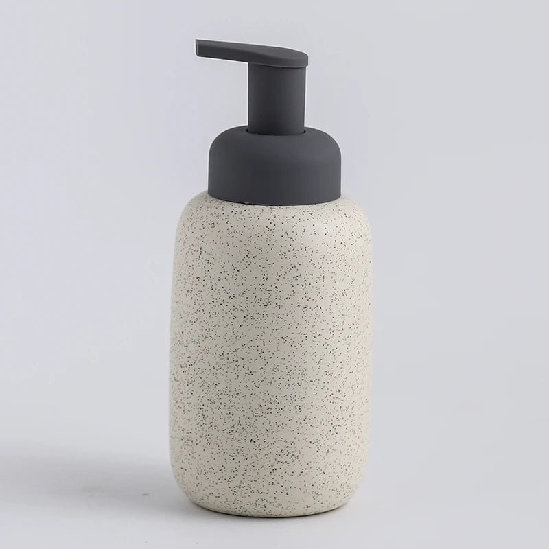 A white ceramic soap dispenser with a sleek design, ideal for modern bathroom decor.