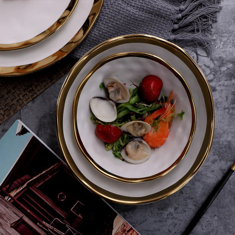 Elegant white serving plate and bowl with a gold rim, perfect for upscale dining and special occasions.