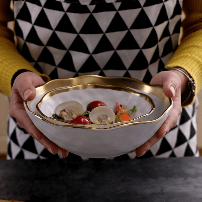 Elegant white serving plate and bowl with a gold rim, perfect for upscale dining and special occasions.