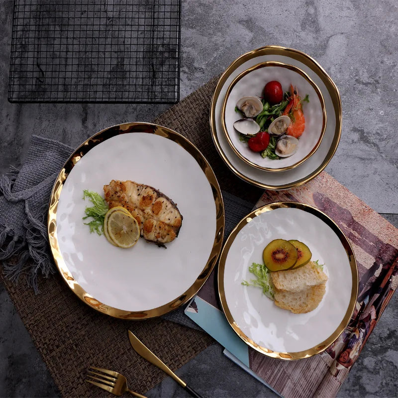 Elegant white serving plate and bowl with a gold rim, perfect for upscale dining and special occasions.