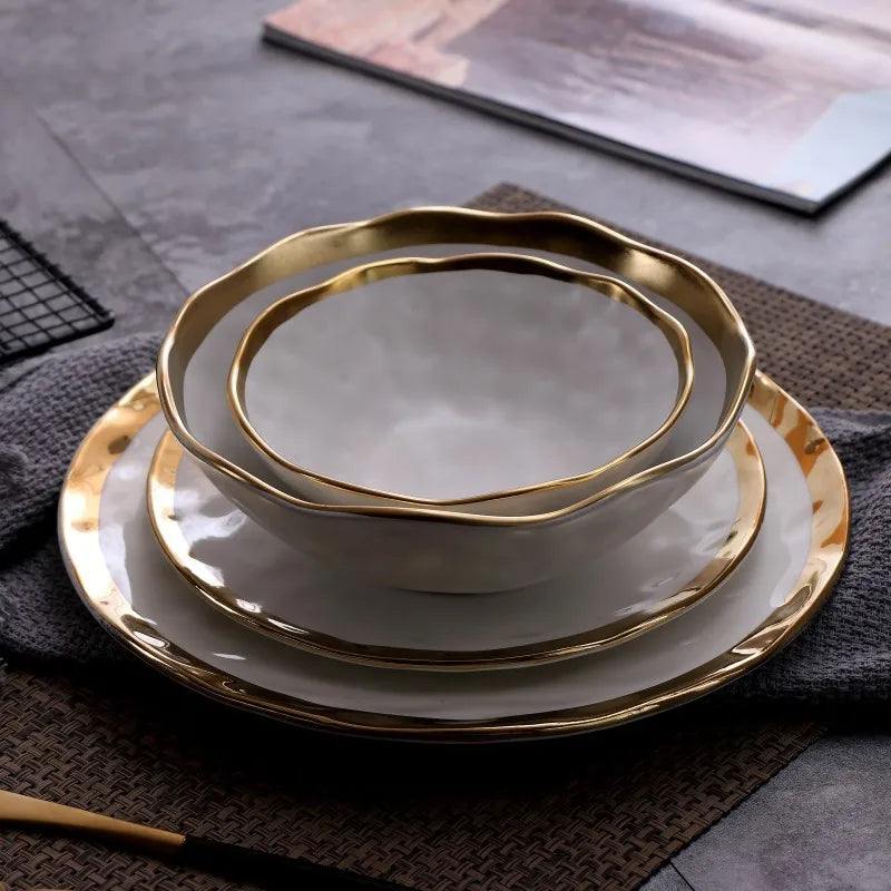 Elegant white serving plate and bowl with a gold rim, perfect for upscale dining and special occasions.