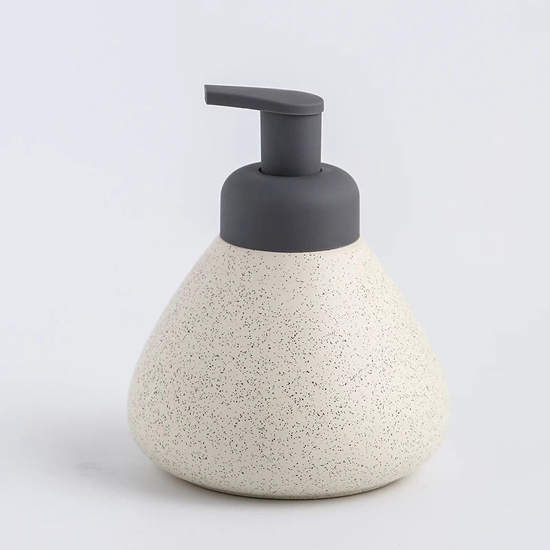 A white ceramic soap dispenser with a sleek design, ideal for modern bathroom decor.