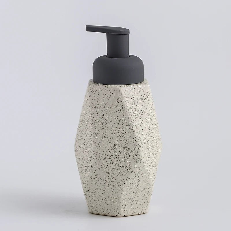 A white ceramic soap dispenser with a sleek design, ideal for modern bathroom decor.