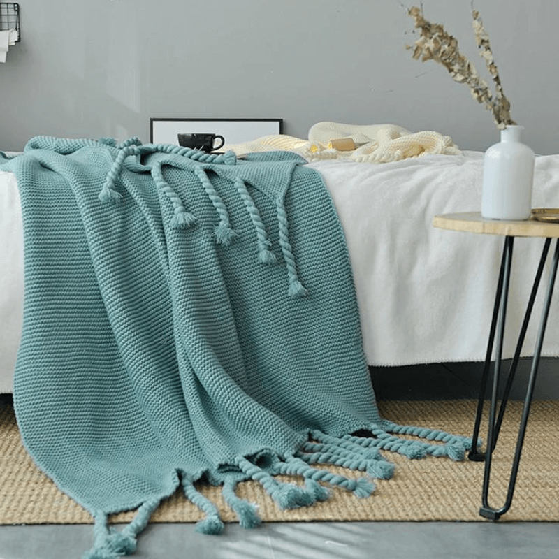 Cozy woven soft knit throw blanket in a warm neutral color.