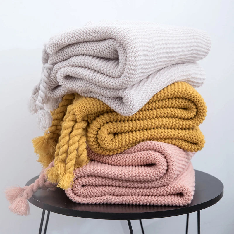 Cozy woven soft knit throw blanket in a warm neutral color.