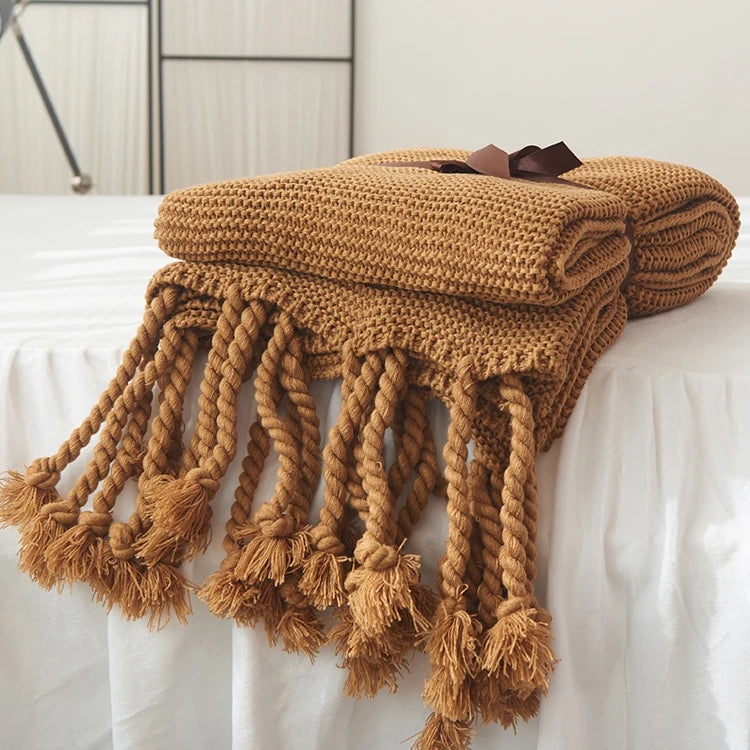 Cozy woven soft knit throw blanket in a warm neutral color.