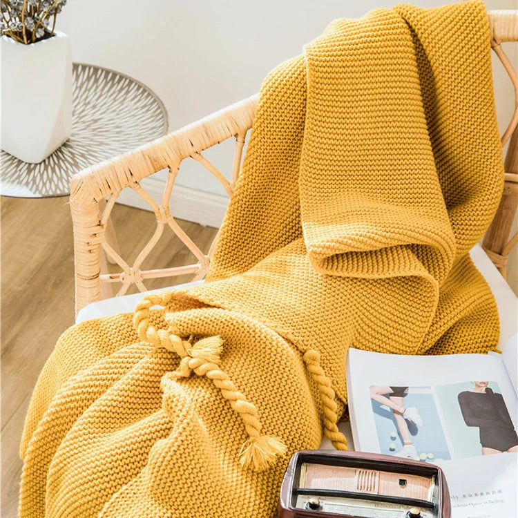 Cozy woven soft knit throw blanket in a warm neutral color.