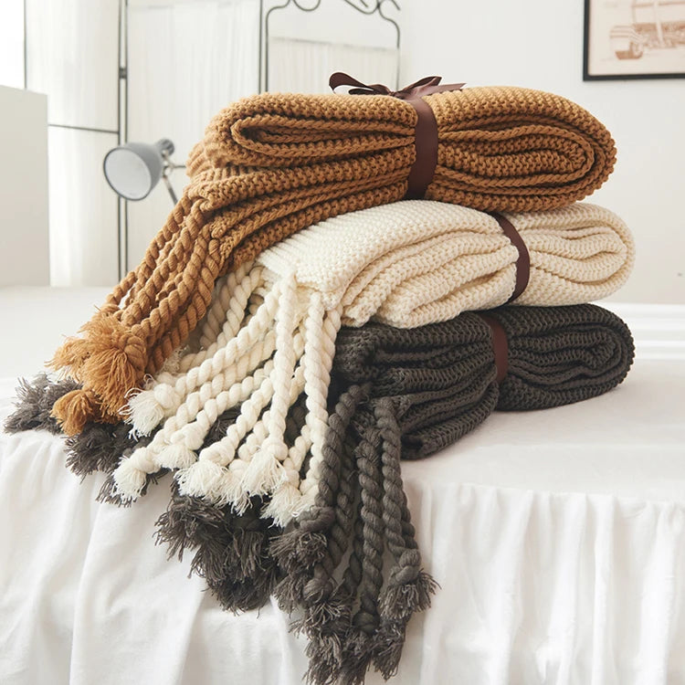 Cozy woven soft knit throw blanket in a warm neutral color.